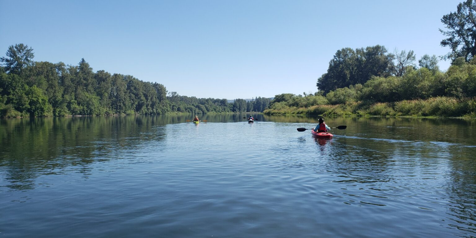River scene with a kayaker in the water.