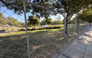 A large chain link fence surrounds Riverview Park.