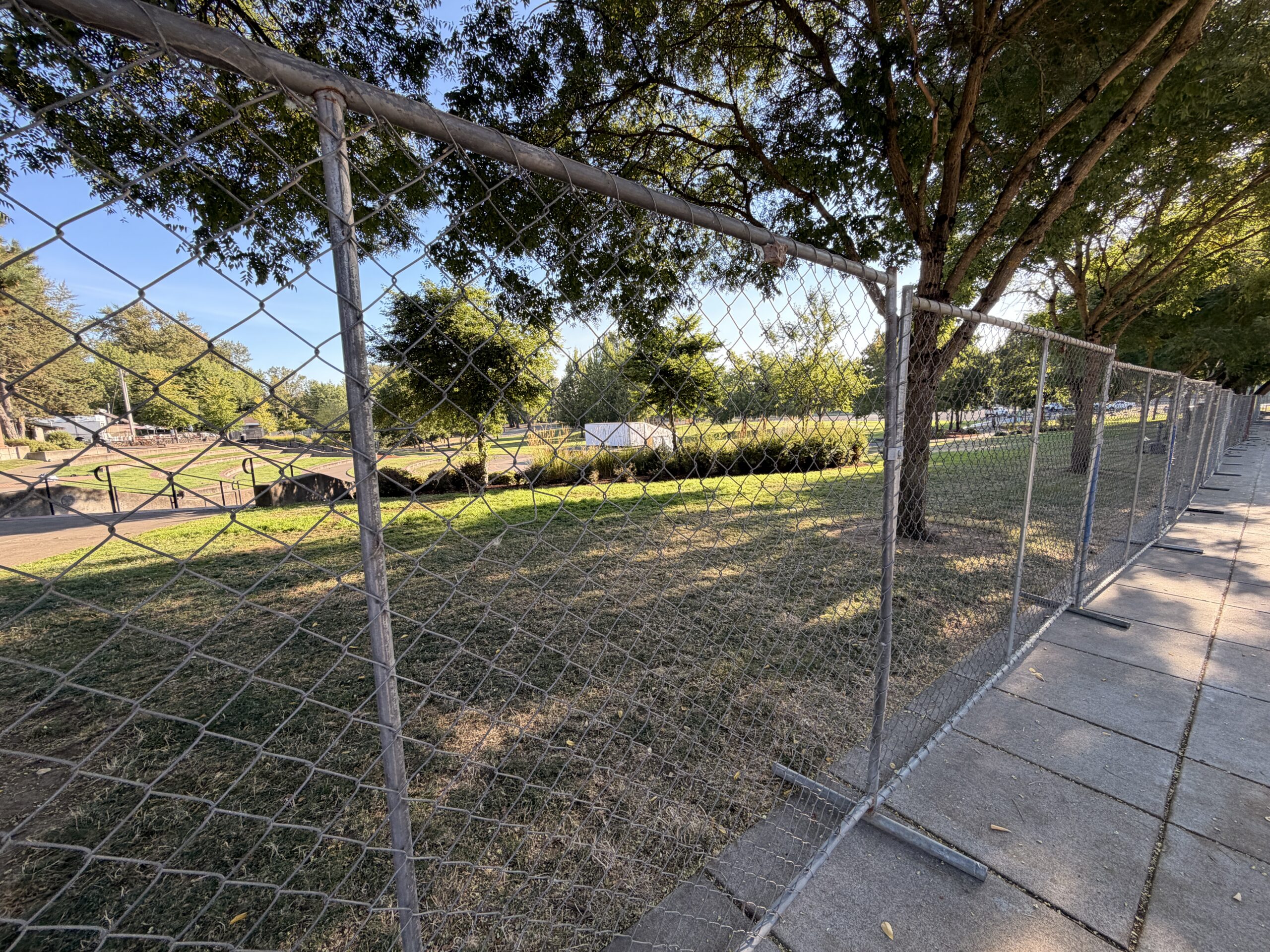 A large chain link fence surrounds Riverview Park.